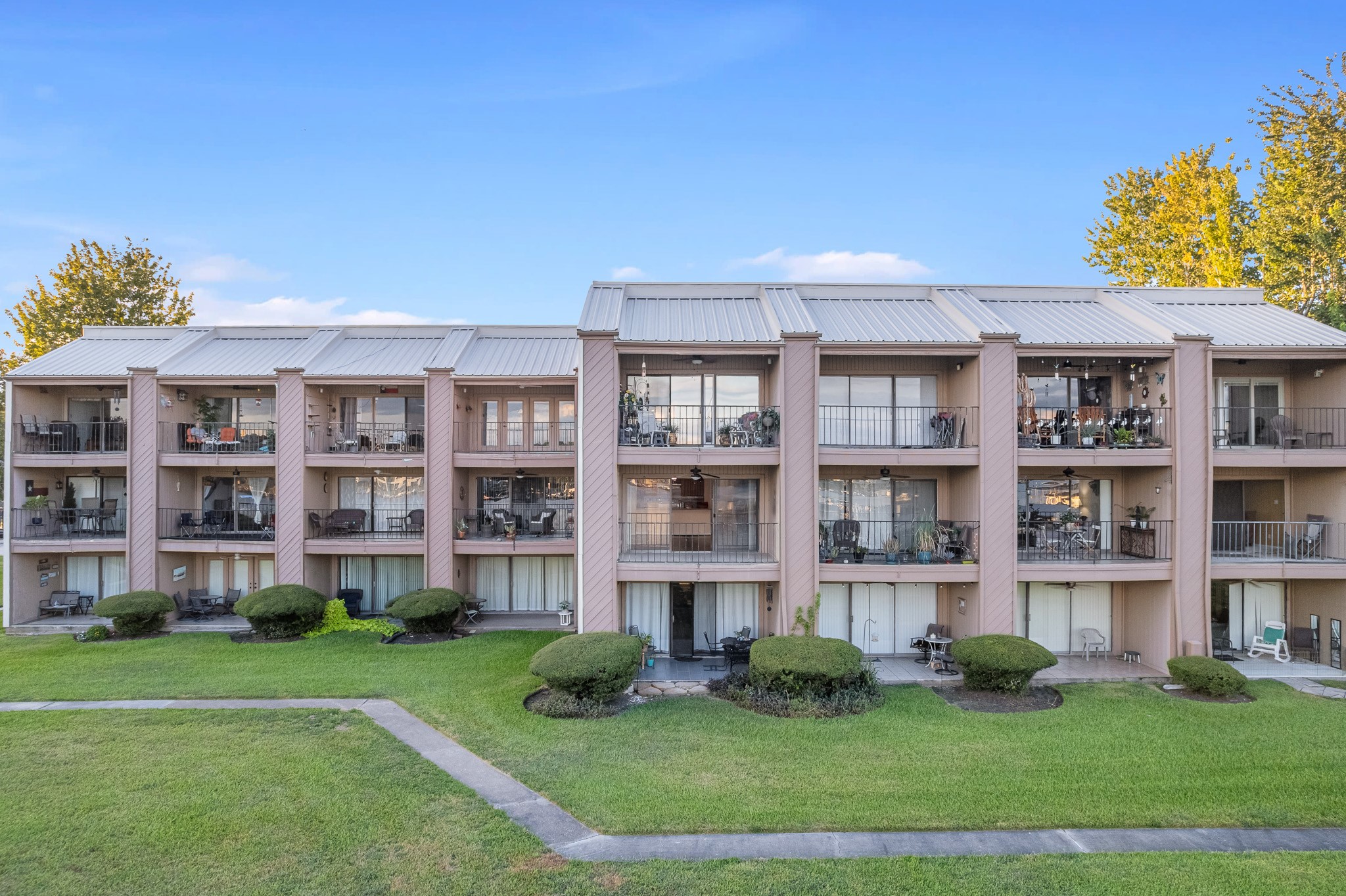 15575 Marina Drive, Unit 215C Montgomery, TX 77356 - Photo 27 of 31 a front view of a building with a yard