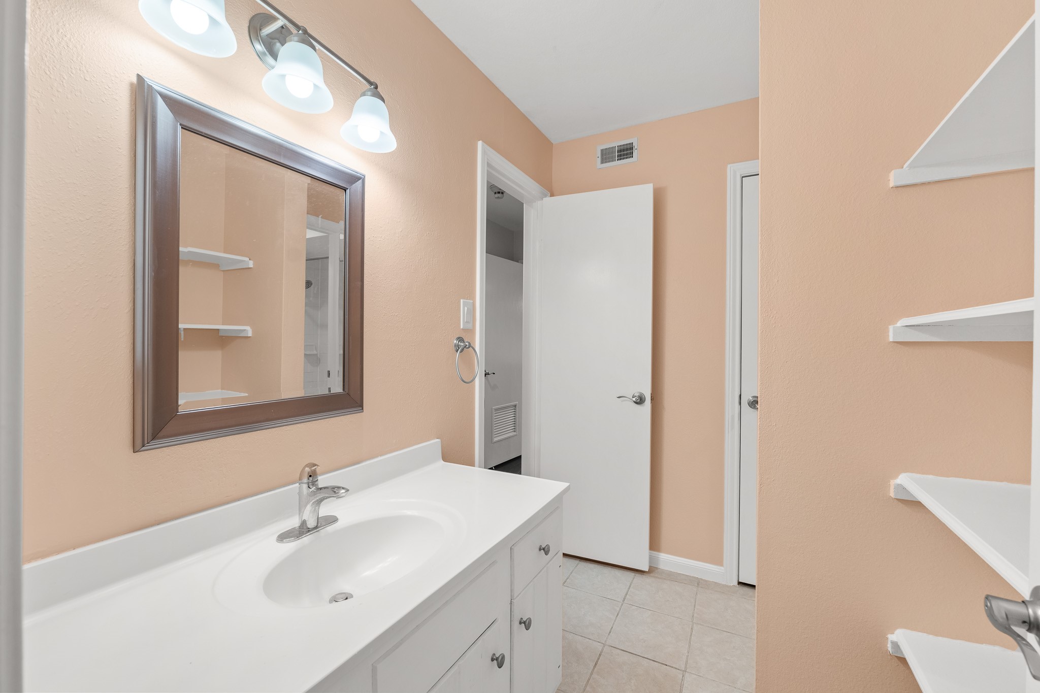 15575 Marina Drive, Unit 215C Montgomery, TX 77356 - Photo 8 of 31 a bathroom with a sink mirror and vanity