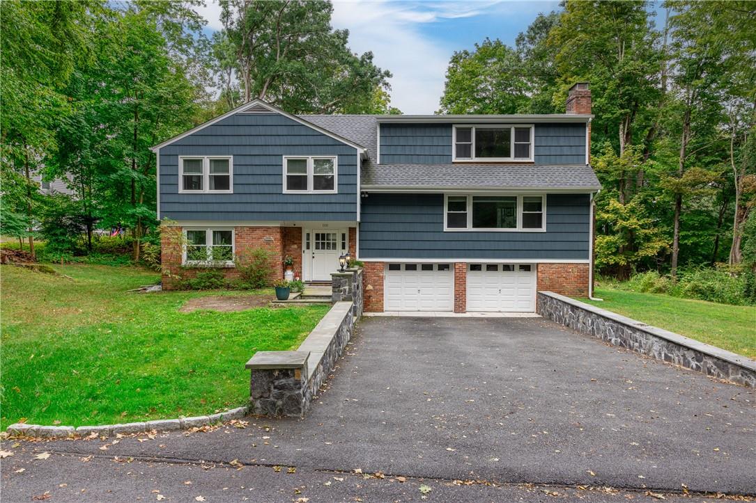 View of front of house featuring a front yard and a garage
