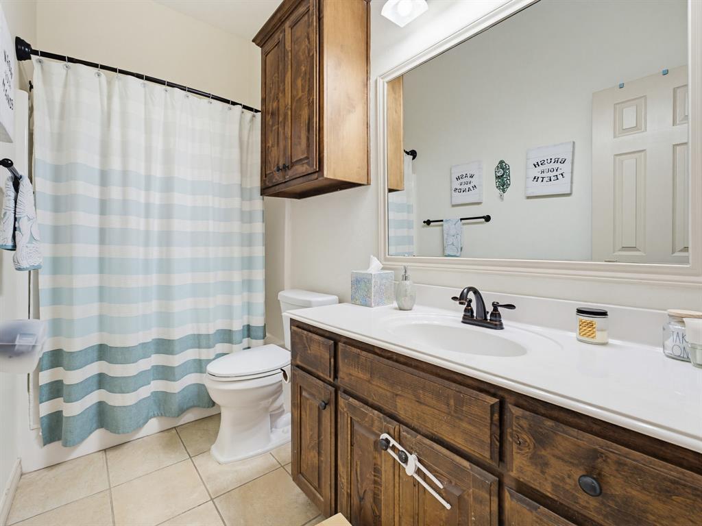 2108 Ridgewood Drive Bridgeport, TX 76426 - Photo 27 of 35 Secondary Bathroom. Single vanity featuring wood-finish cabinetry, white countertop, and integrated sink