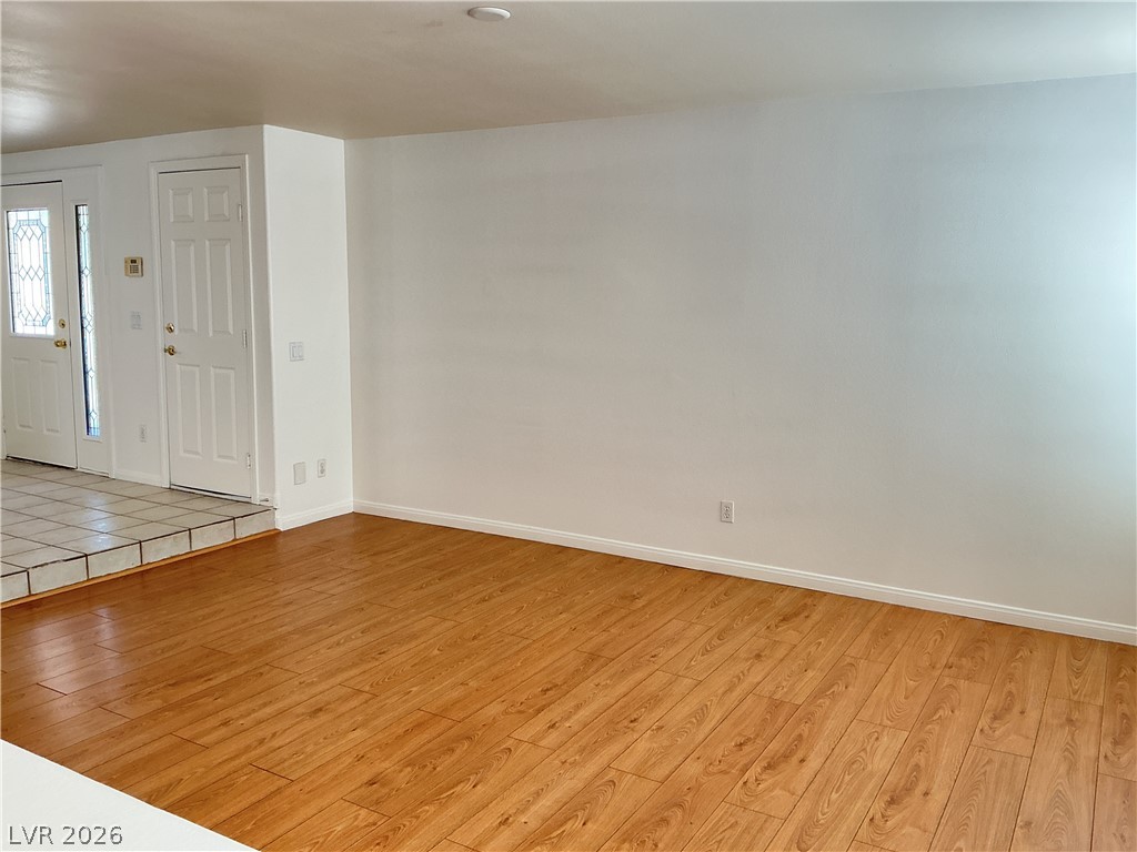 10975 Calcedonian Street Las Vegas, NV 89141 - Photo 7 of 25 This bright living space features warm hardwood floors and a welcoming tiled entry.