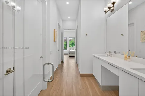 a bathroom with a double vanity sink and a mirror