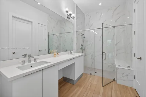 a bathroom with a double vanity sink and a mirror