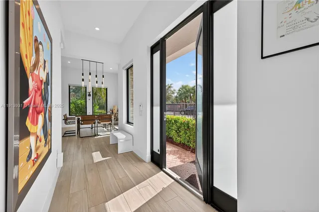 a view of a living room hardwood floor and a large window