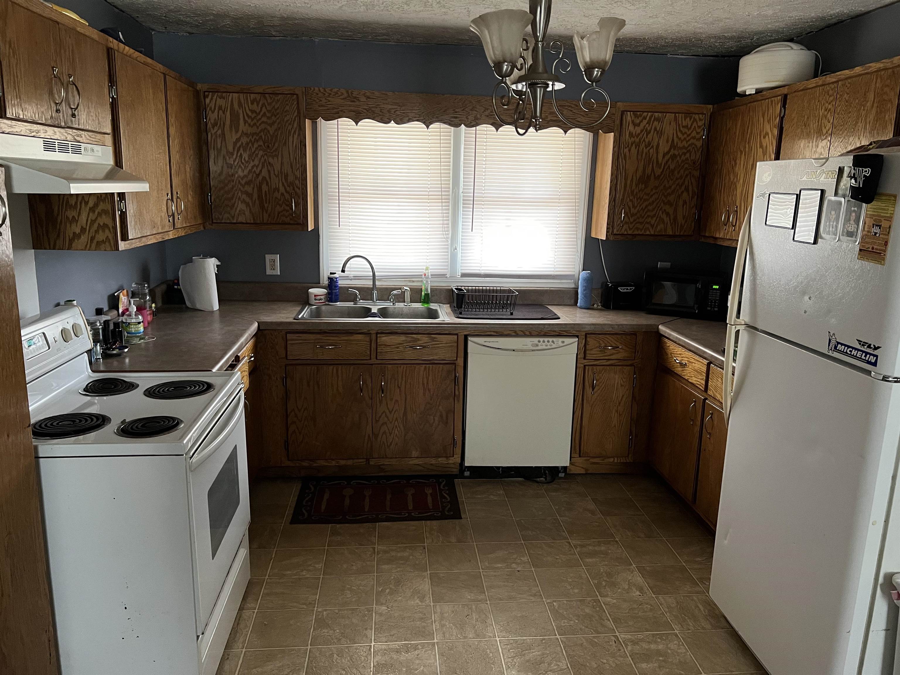 2388 Chambers Store Road Michie, TN 38357 - Photo 2 of 13 a kitchen with stainless steel appliances granite countertop a stove a sink a refrigerator and a microwave