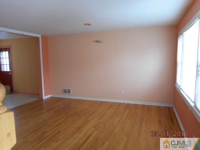 123 Vineyard Road Edison, NJ 08817 - Photo 5 of 14 an empty room with wooden floor and windows