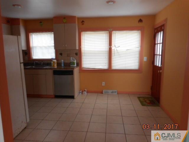 123 Vineyard Road Edison, NJ 08817 - Photo 6 of 14 a kitchen with a cabinets a window and a counter top space