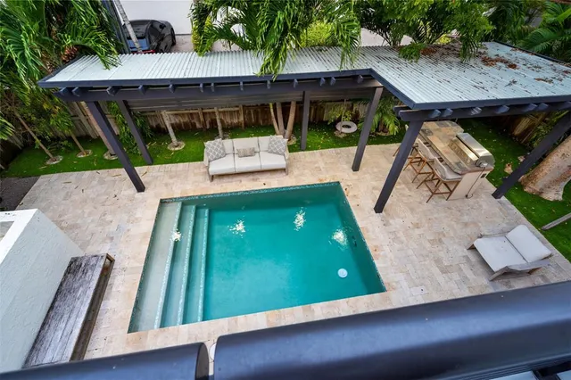 swimming pool view with a seating space
