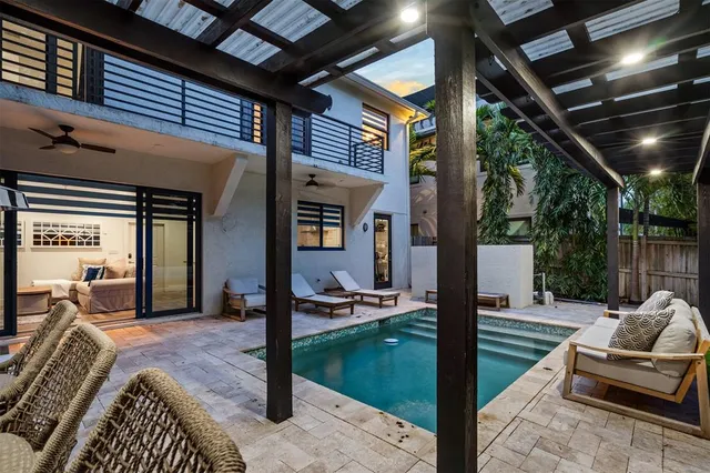 a view of a porch with furniture and floor to ceiling window