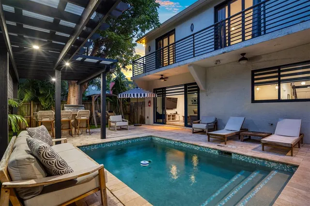 a view of swimming pool with outdoor seating