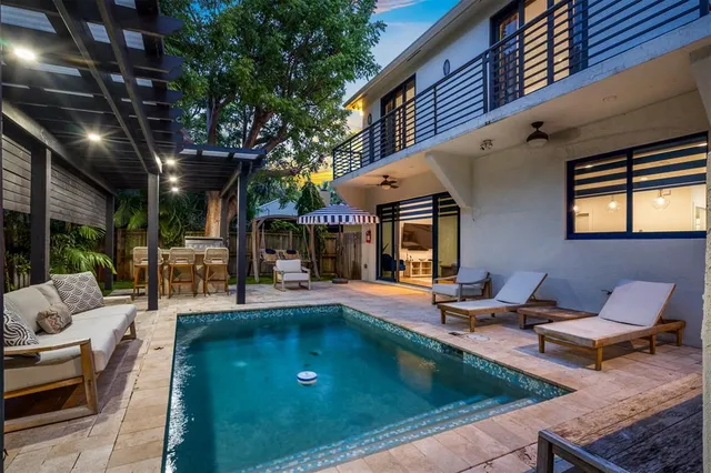 a view of swimming pool with outdoor seating