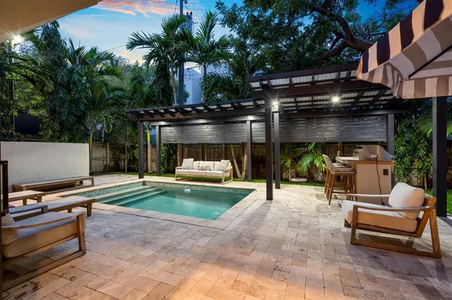 a view of a patio with a table and chairs under an umbrella