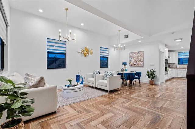 a living room with furniture and a dining table with window