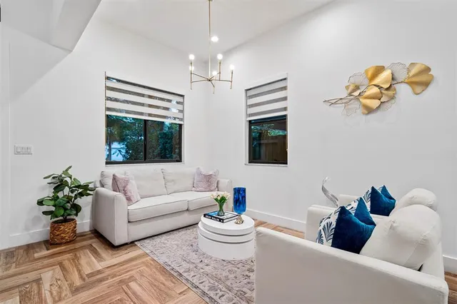 a living room with furniture and a chandelier