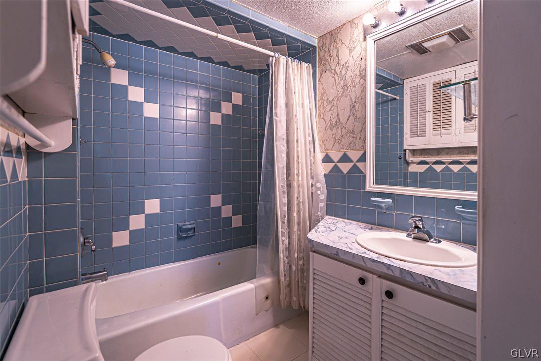 1177 Arcadia Street Bethlehem, PA 18018 - Photo 21 of 32 a bathroom with a granite countertop bathtub shower sink vanity and toilet