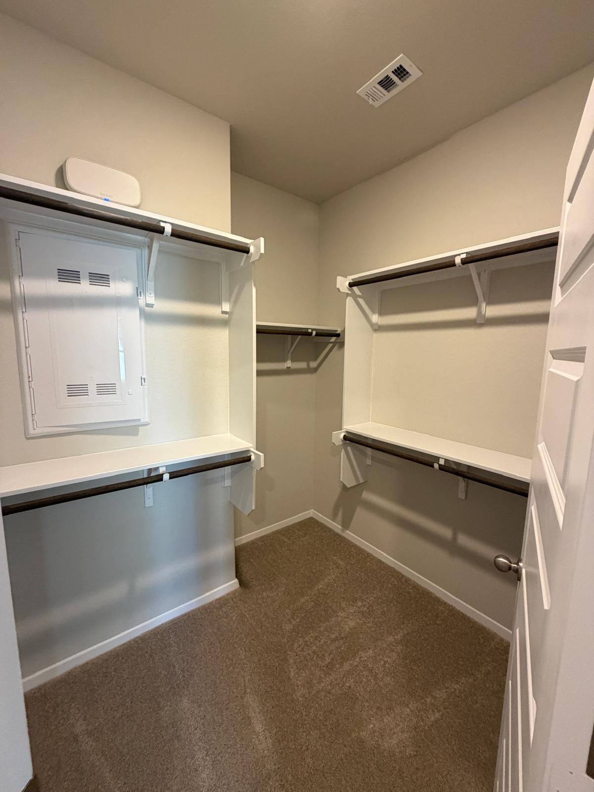 2612 Towy Road Manor, TX 78653 - Photo 22 of 35 Ample shelving and hanging space defines this well-organized walk-in closet.
