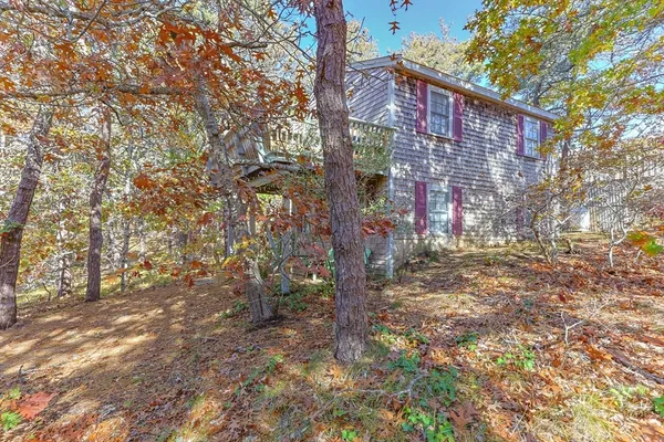 a brick building with a tree in the background