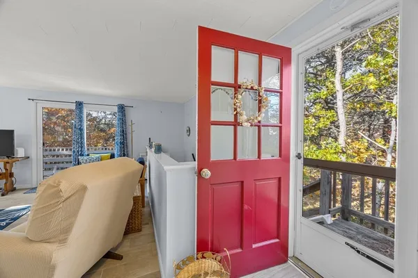 a bedroom with a bed and large windows