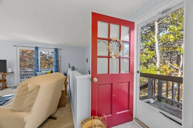 a bedroom with a bed and large windows