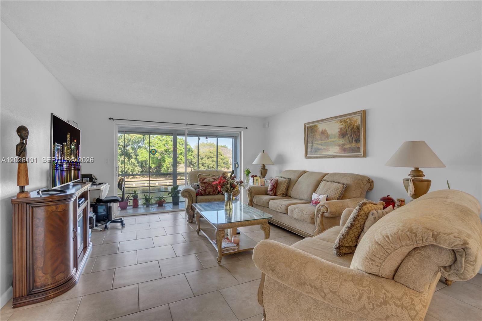 3551 Inverrary Drive, Unit 208 Lauderhill, FL 33319 - Photo 5 of 34 a living room with furniture and a flat screen tv