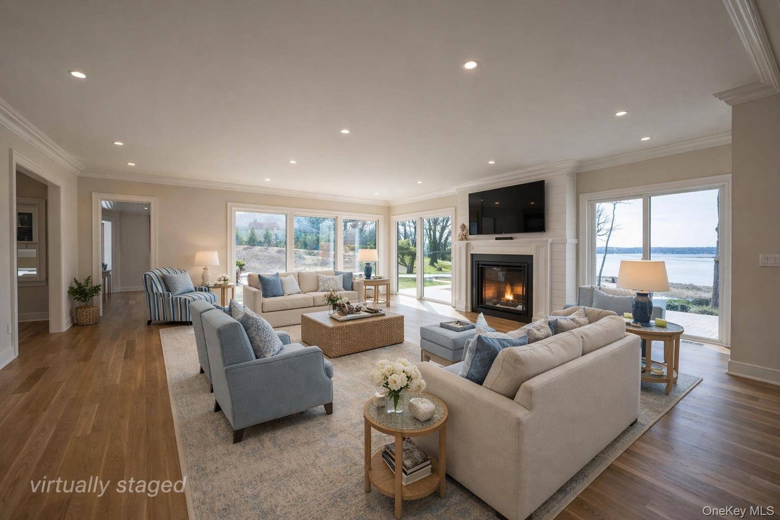 106 Cove Road Asharoken, NY 11768 - Photo 8 of 46 Bright living space featuring a fireplace, wood-finish flooring, recessed lighting, and expansive sliding glass doors