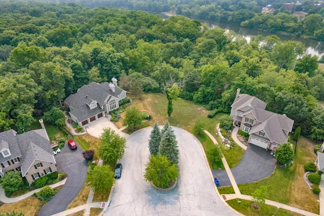 an aerial view of a house with outdoor space and lake view