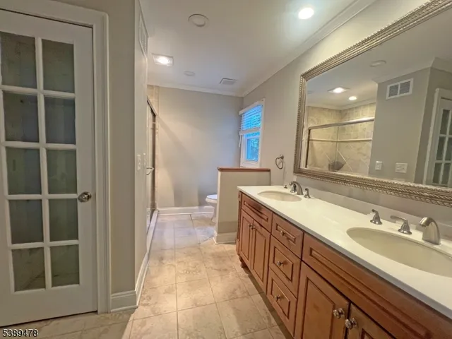 a spacious bathroom with a double vanity sink and a mirror