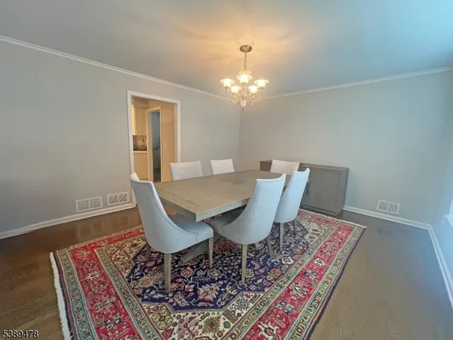 a view of a dining room with furniture and chandelier