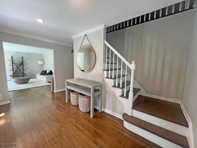 a living room with fireplace furniture and a wooden floor