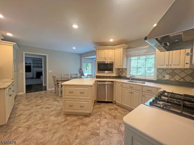 a kitchen that has a sink and a stove in it