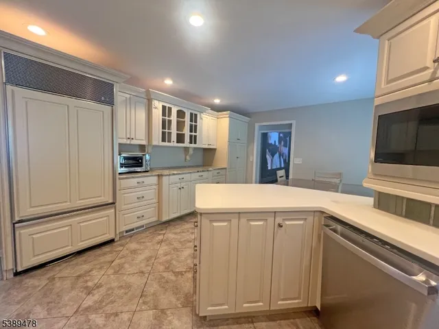 a kitchen with granite countertop cabinets and oven
