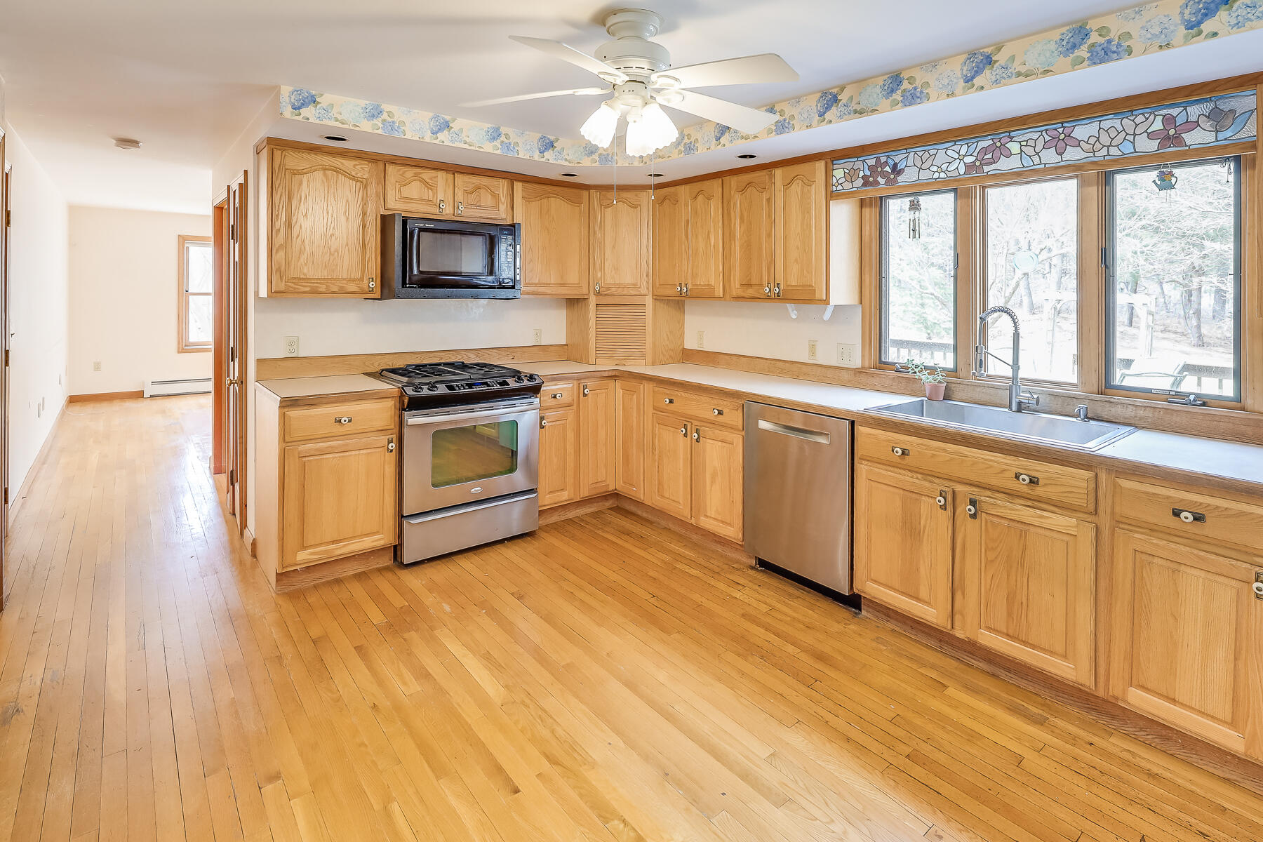 40 Meadowbrook Road Mashpee, MA 02649 - Photo 7 of 31 a kitchen with granite countertop a stove a sink and a microwave