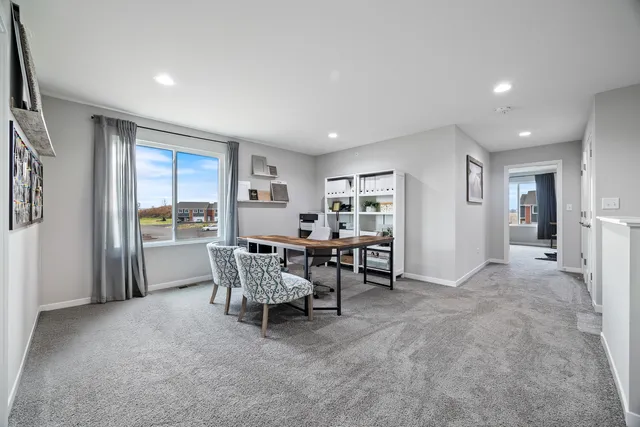 a view of a livingroom with furniture and a window