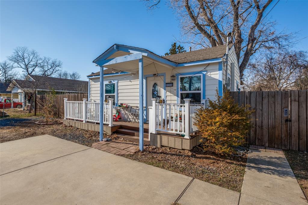 a front view of house with a garden