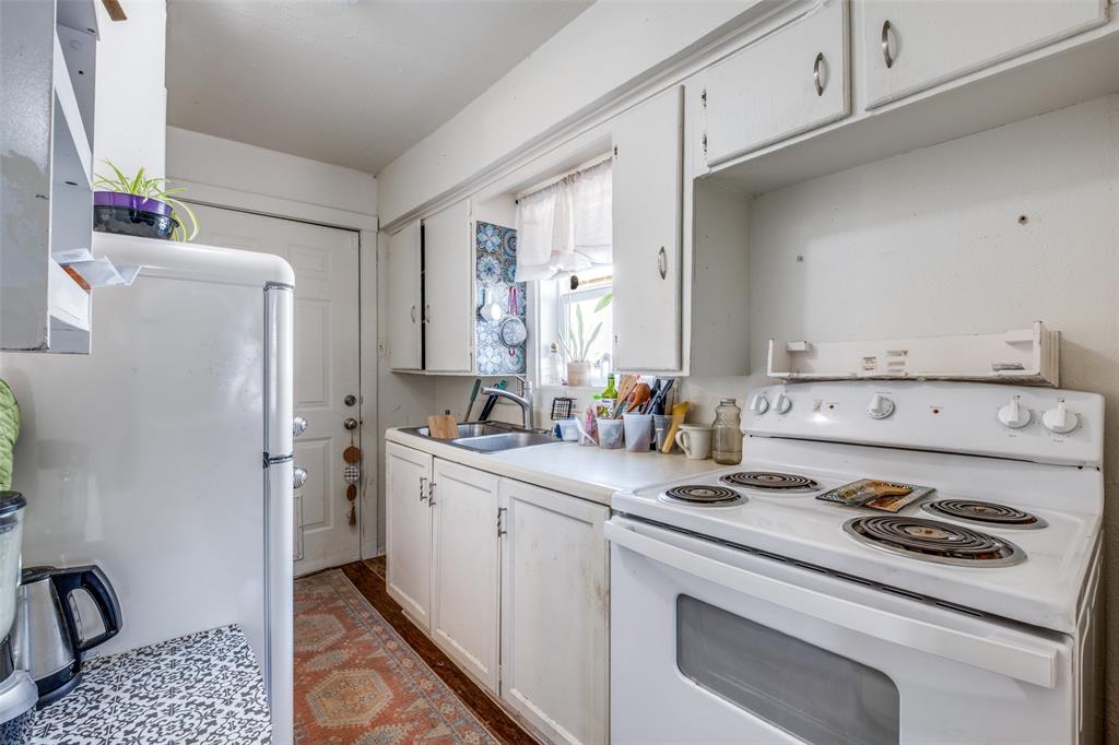 4755 Yancy Street Dallas, TX 75216 - Photo 5 of 12 a kitchen with a sink stove and refrigerator