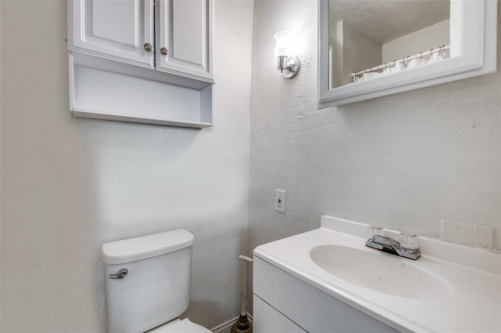 4755 Yancy Street Dallas, TX 75216 - Photo 9 of 12 a bathroom with a sink and a toilet
