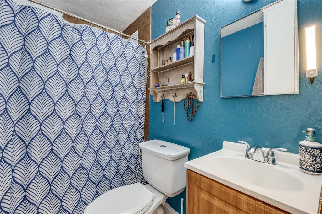 4755 Yancy Street Dallas, TX 75216 - Photo 10 of 12 a bathroom with a sink and a toilet
