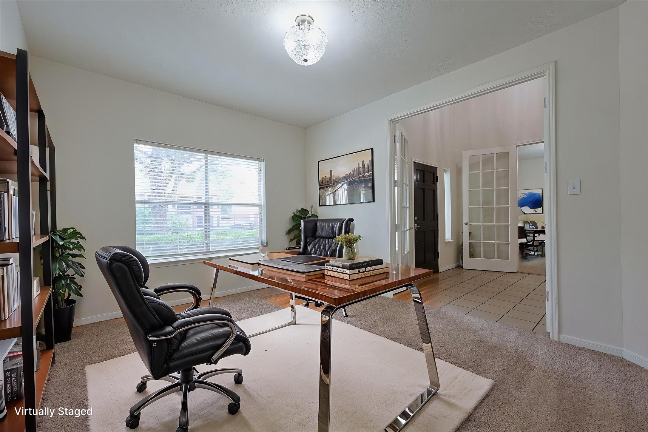 23019 Eastgate Village Drive Spring, TX 77373 - Photo 20 of 46 This is a virtually staged home office featuring a sleek glass desk, comfortable chair, and a large window providing natural light. The space is open and connected to a tiled hallway through double doors, creating an inviting and functional work environment.