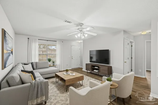 a living room with furniture and a flat screen tv