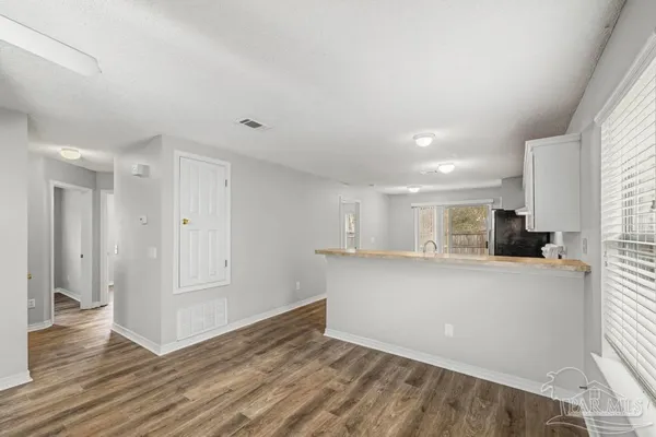 a view of kitchen and wooden floor
