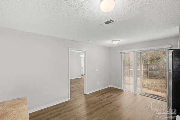 a view of wooden floor and windows in a room
