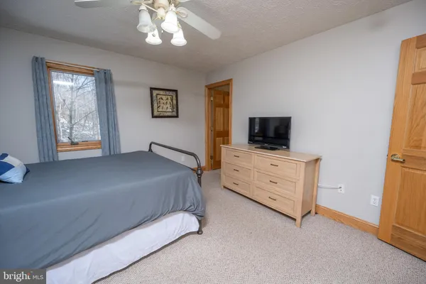 a spacious bedroom with a bed and a large window
