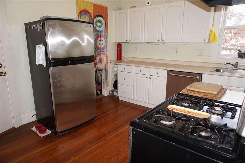 52 Patten Street, Unit 2 Boston, MA 02130 - Photo 11 of 18 a kitchen with granite countertop a stove and a refrigerator