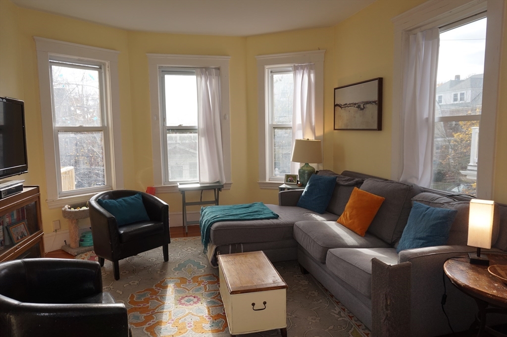52 Patten Street, Unit 2 Boston, MA 02130 - Photo 2 of 18 a living room with furniture and a flat screen tv