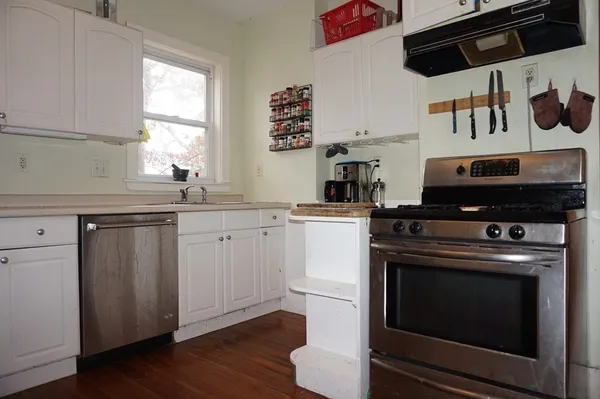 a kitchen with stainless steel appliances a stove a sink and a microwave