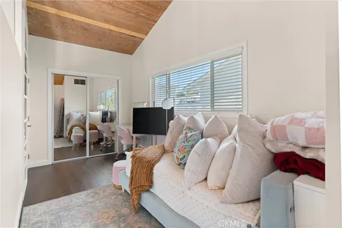 a bedroom with furniture and a flat screen tv
