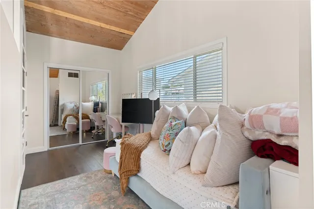 a bedroom with furniture and a flat screen tv