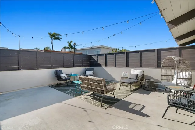 a roof deck with table and chairs