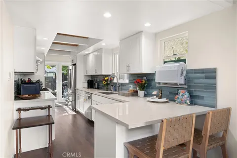 a kitchen with a table chairs stove and cabinets