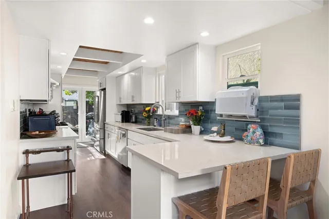 a kitchen with a table chairs stove and cabinets